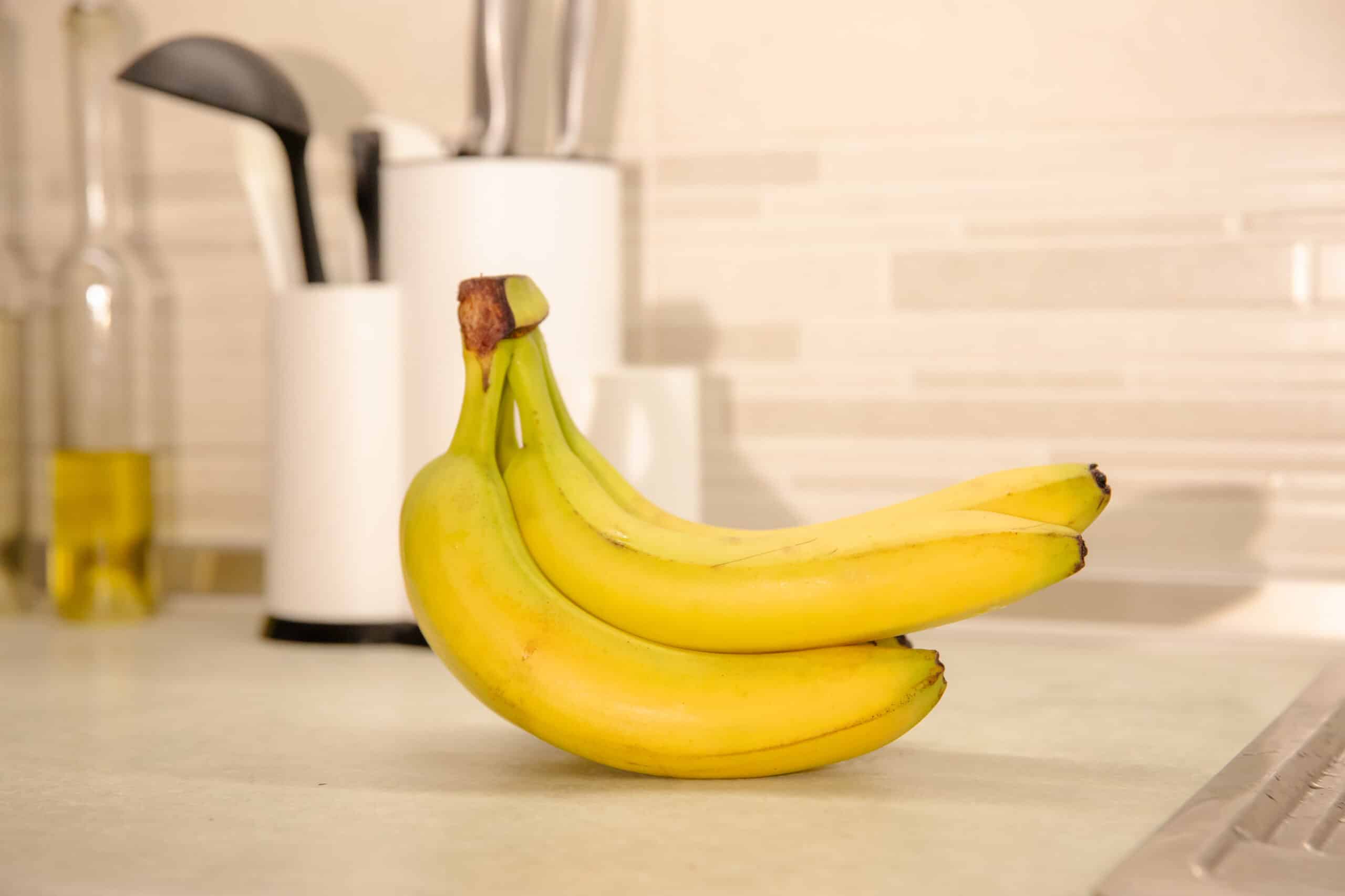 ripe bananas on a table: colorful and healthy fruit stock photography