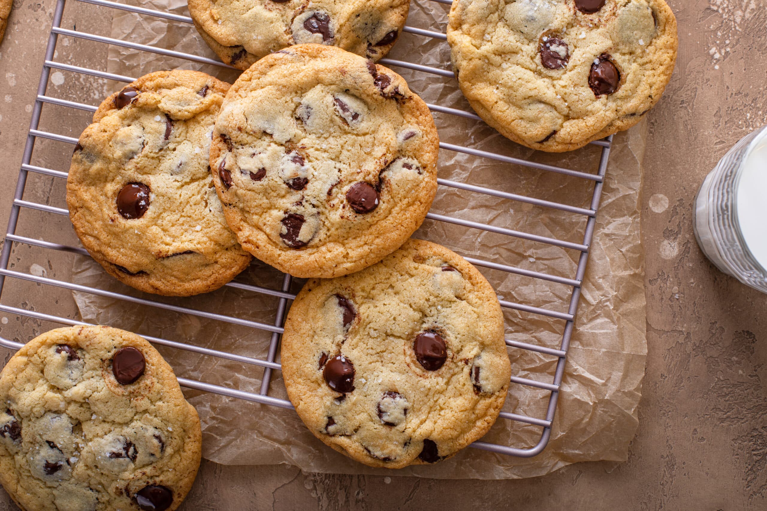 chocolate chip cookies with flaky salt on a cooling rack